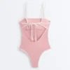 Fato de banho bandeau com acabamentos contrastantes Fato de banho bandeau com acabamentos contrastantes